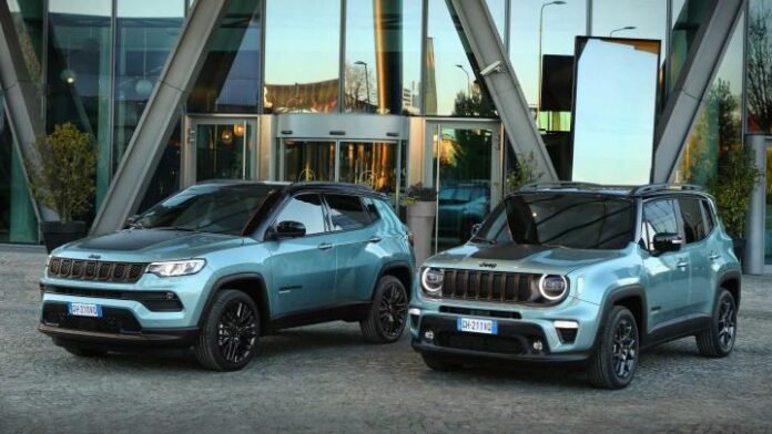 a couple of blue suvs parked outside a building