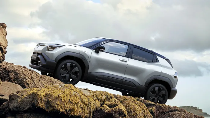 Maruti Suzuki e-Vitara electric SUV parked on an urban street, showcasing its modern design and eco-friendly appeal.